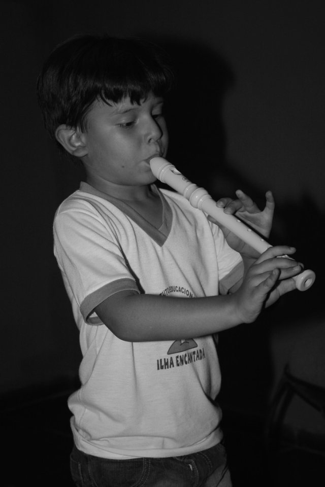 Gabriel Albuquerqüe as a child, playing the flute